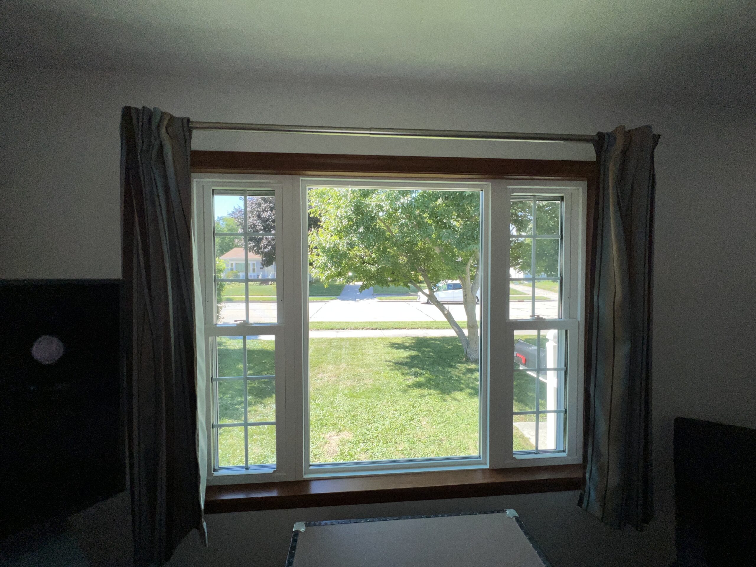 Triple window, single pane in center with curtains