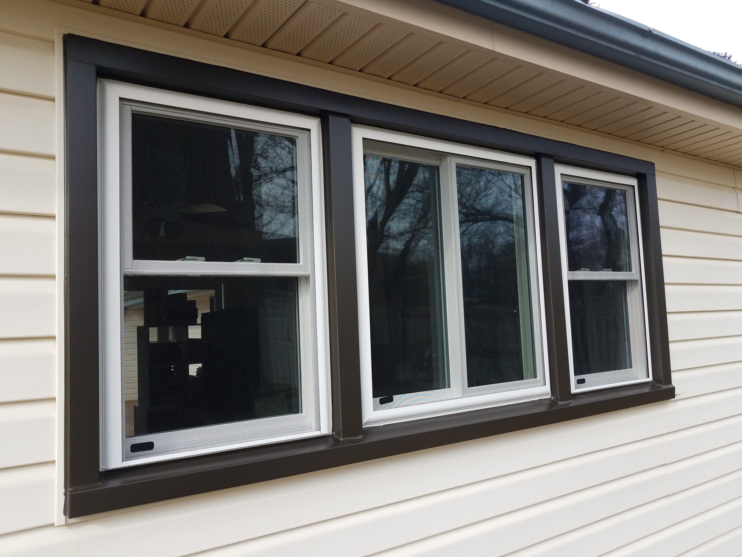 Exterior of new windows triple with white frames and black facing