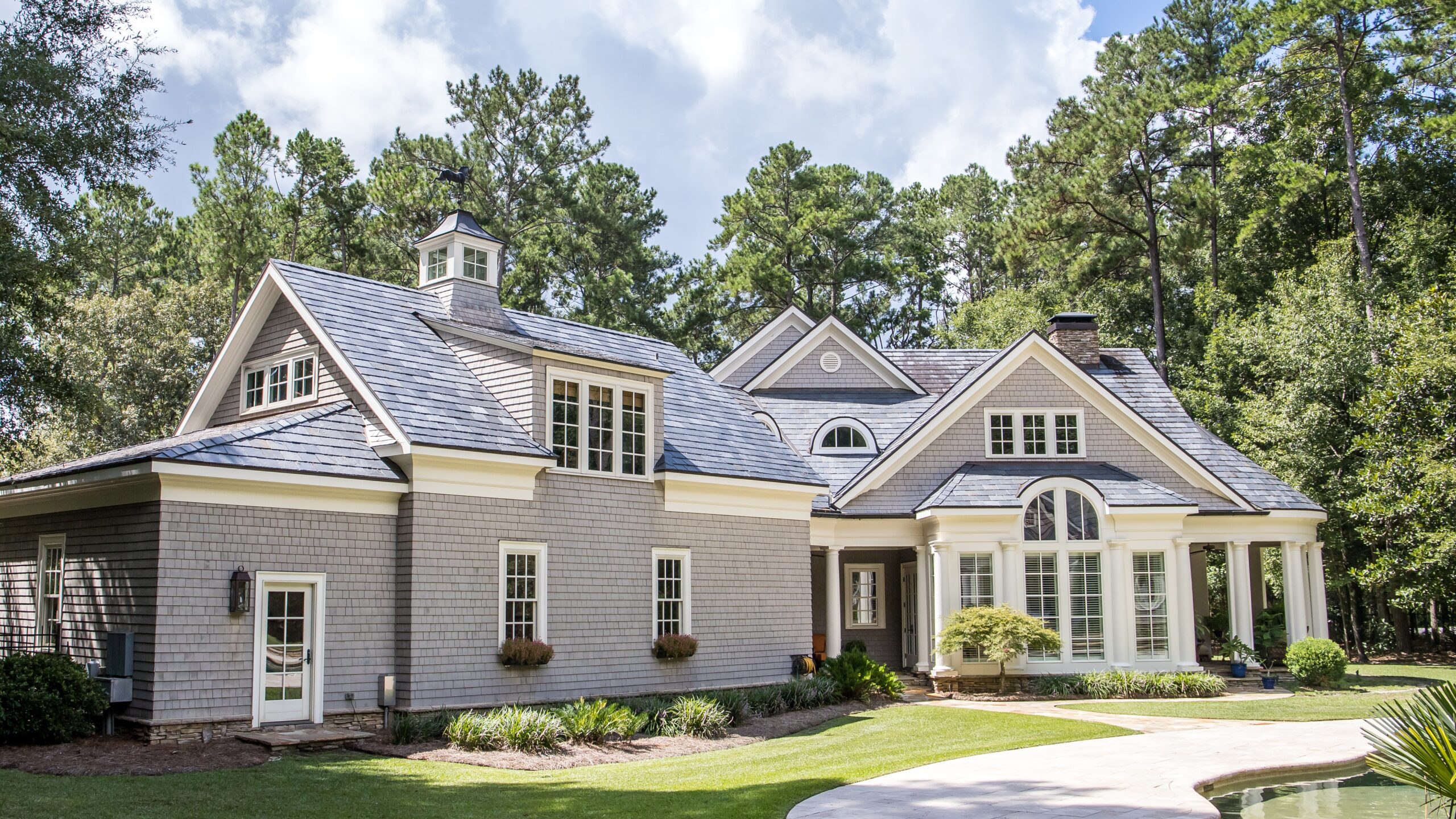 A home with gray siding and white trim windows