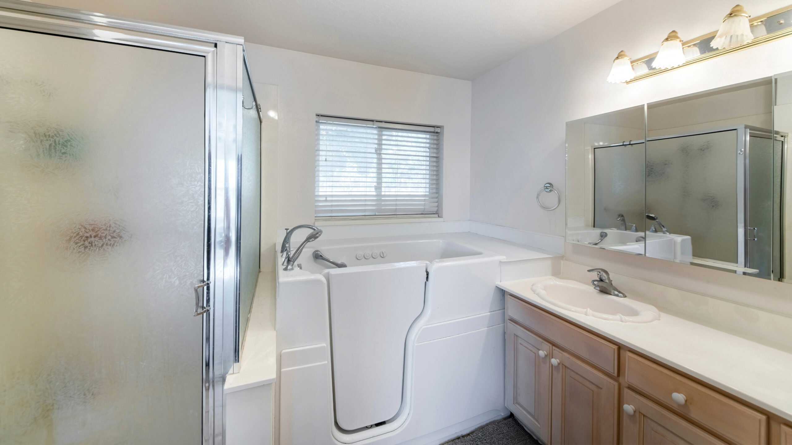 A white walk-in tub next to a walk-in shower
