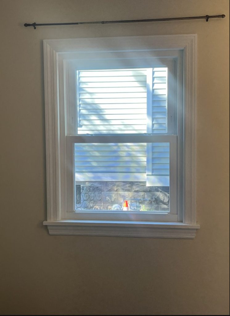 White double-hung replacement window with new interior trim in a Greendale, WI home, installed by TightSeal Exteriors & Baths
